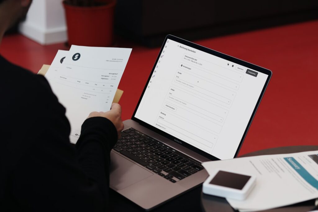 Accounts Receivable Systems: Complete Business Guide A person sitting at a desk with a laptop and papers