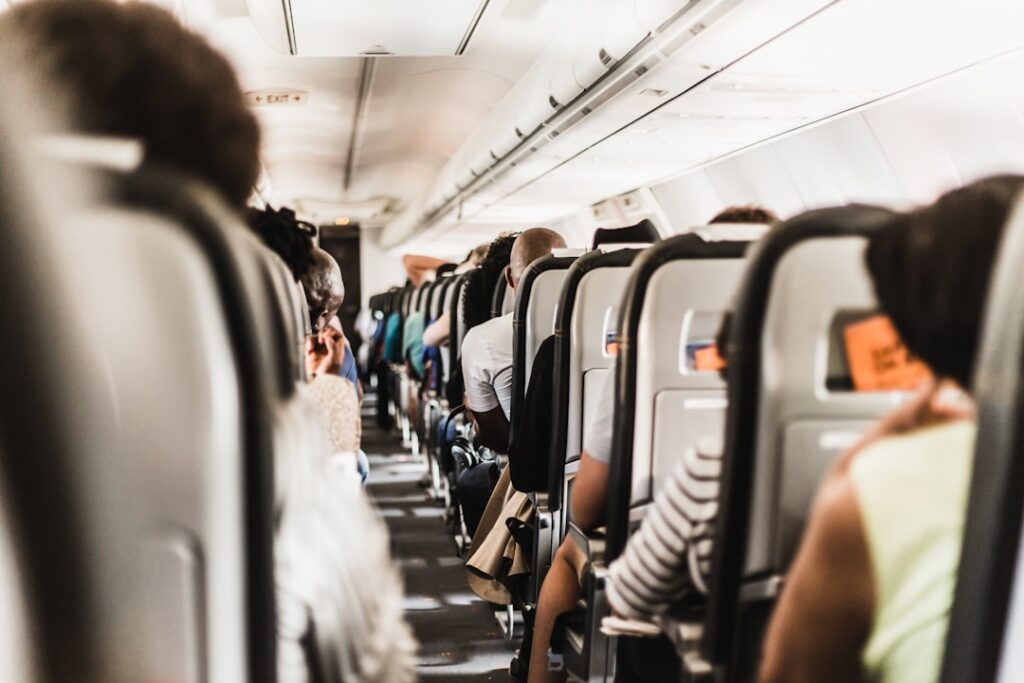 Air Fares Jump 25% as Iran Conflict Disrupts Flight Routes people seating in vehicle