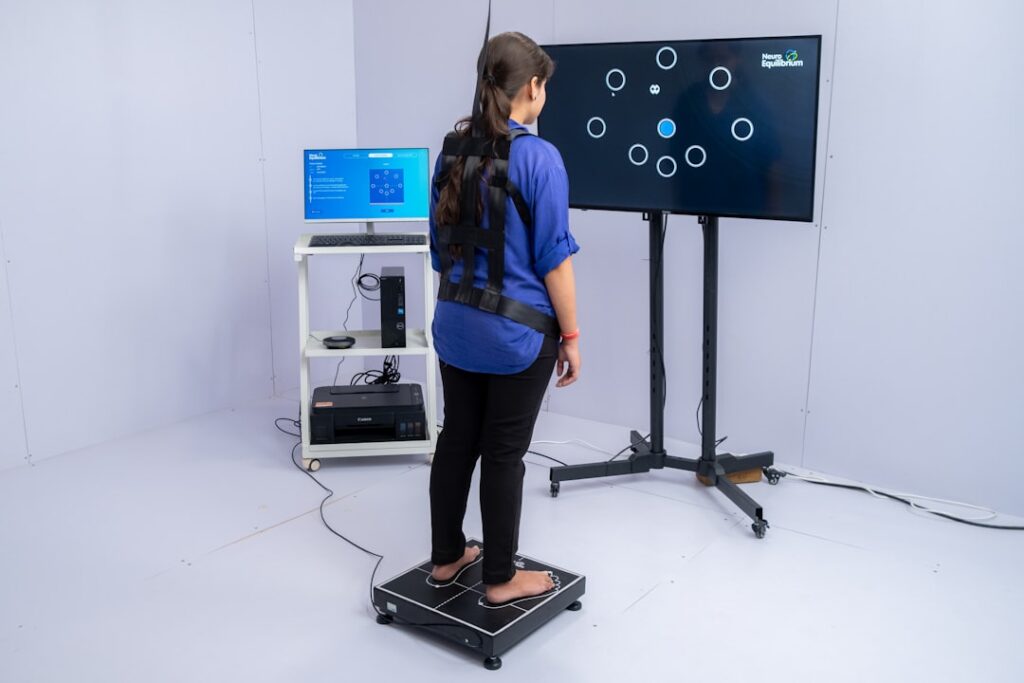 Bilateral Stimulation: The Science Behind Stress Relief Woman stands on pressure plate with sensors on-screen interactive game.