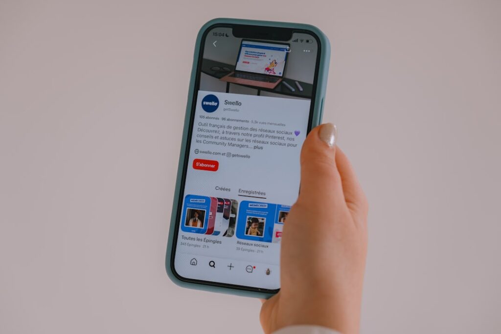 Building Brand Communities: Smart Strategies Over Public Pitfalls Hand holding a smartphone displaying a social media feed.