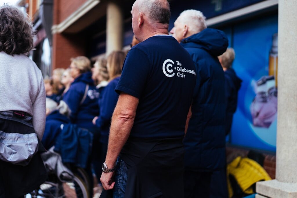 The Eldercare Crisis Reshaping Corporate Leadership People in dark t-shirts standing in a line.