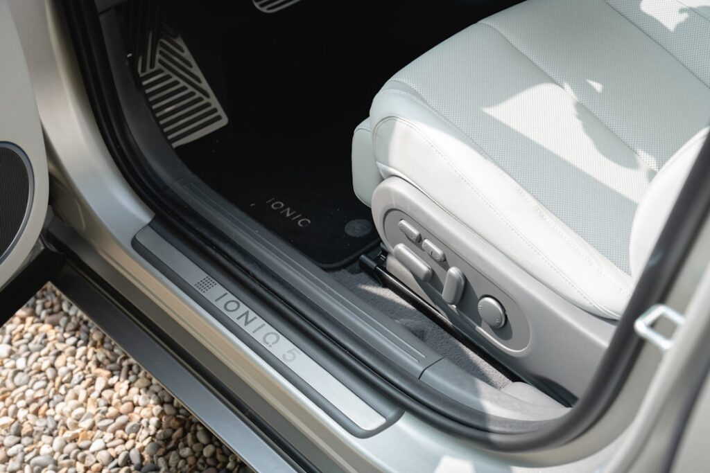 Chinese EV Maker Patents In-Vehicle Toilet Technology Interior view of a modern car's driver seat and door.