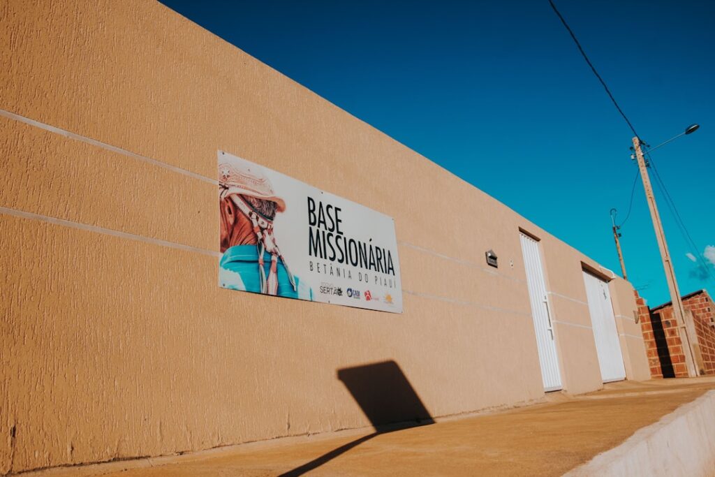 Pastor Dino Rizzo Launches Serve Day 2026 Campaign Missionary base sign on a textured wall