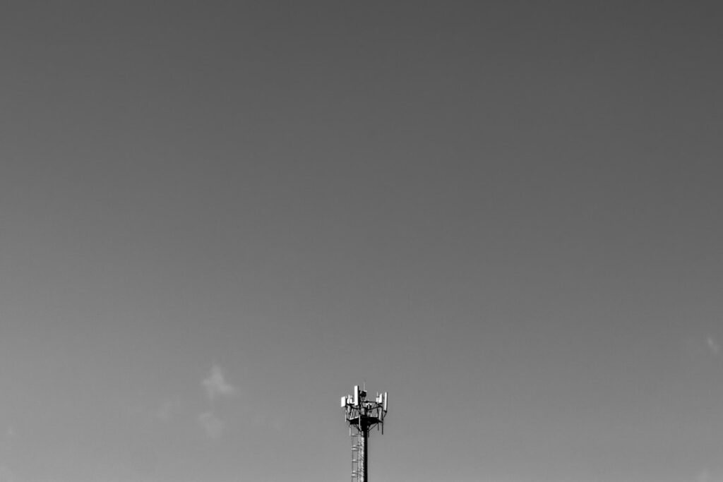 Wireless Investment Surge Driven by AI and IoT Adoption Cell tower against a clear sky