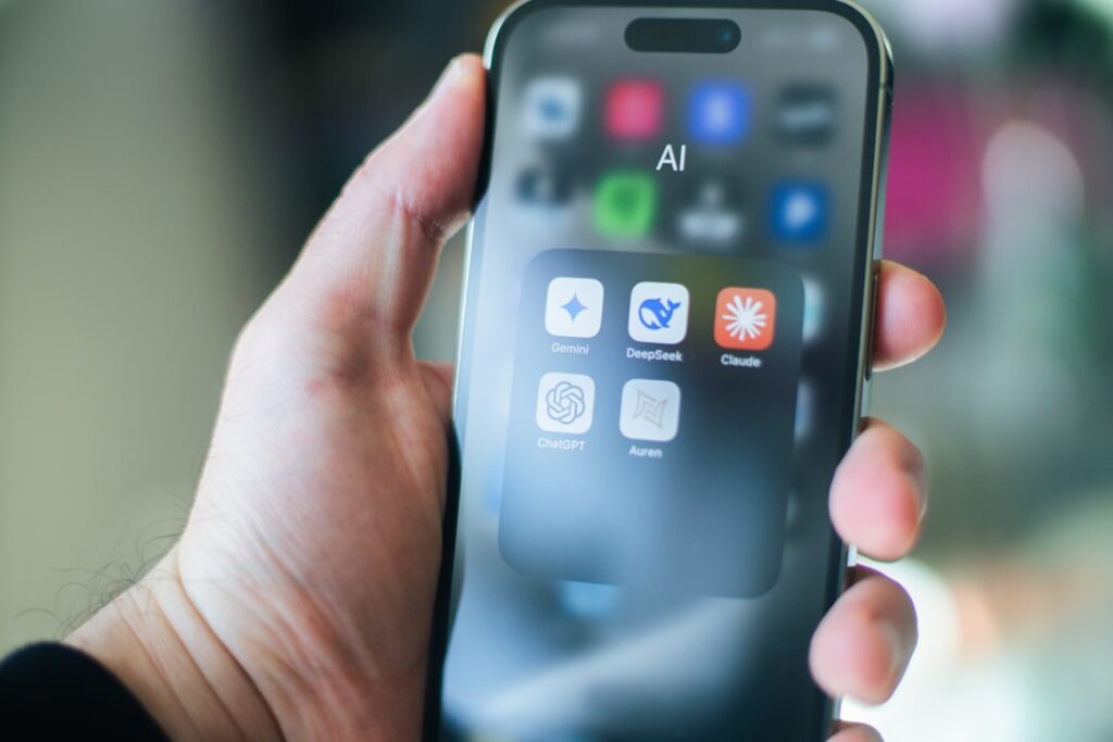 App Store Surge: AI Fuels Mobile Software Boom in 2026 A hand holds a smartphone with various apps.