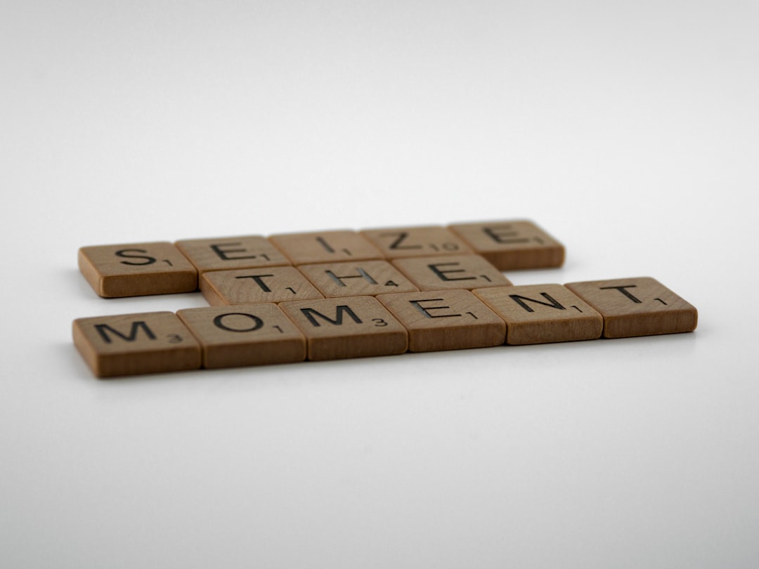 Home three scrabble tiles spelling the word seize the moment