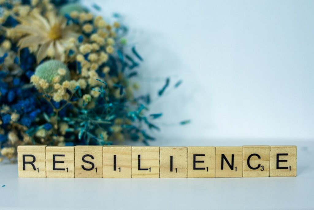 Real Resilience Isn't Bouncing Back—It's Moving Forward a scrabble type block spelling the word resilince
