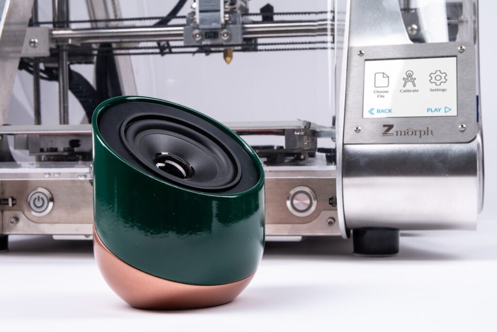 Bambu Lab X2D: Dual Extrusion 3D Printing Redefined round black and brown portable speaker in close-up photography