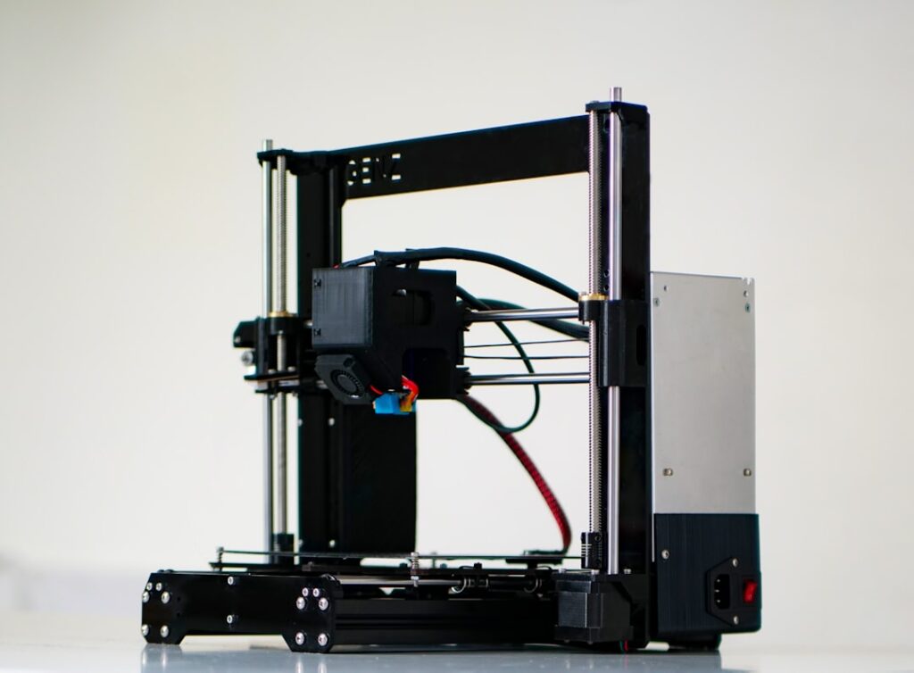 Bambu Lab X2D: Dual-Extrusion 3D Printing Revolution a 3d printer with wires attached to it