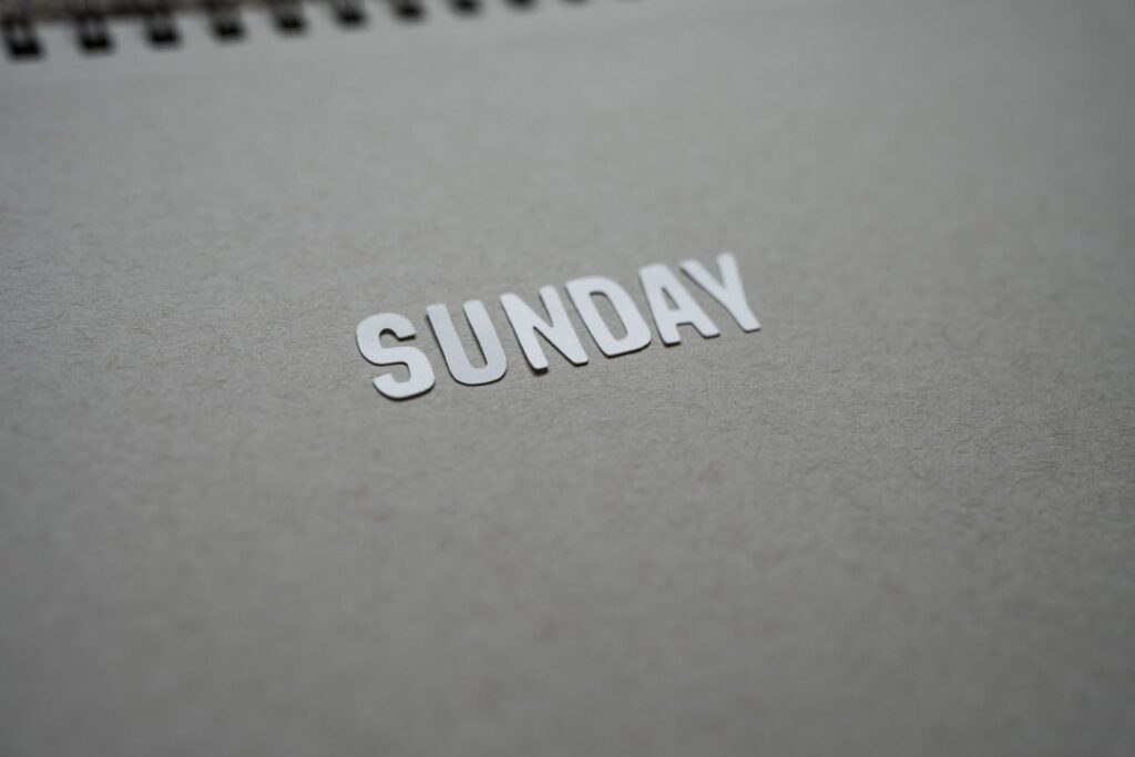 Sunday Reset Habit Could Boost Your Annual Income by $25K the word sunday is cut out of a notebook