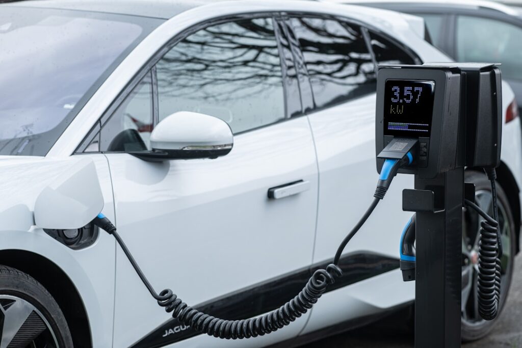 Rosiwit Unveils Eco-Smart Cleaning Tech at Amsterdam 2026 White electric car charging at a station.