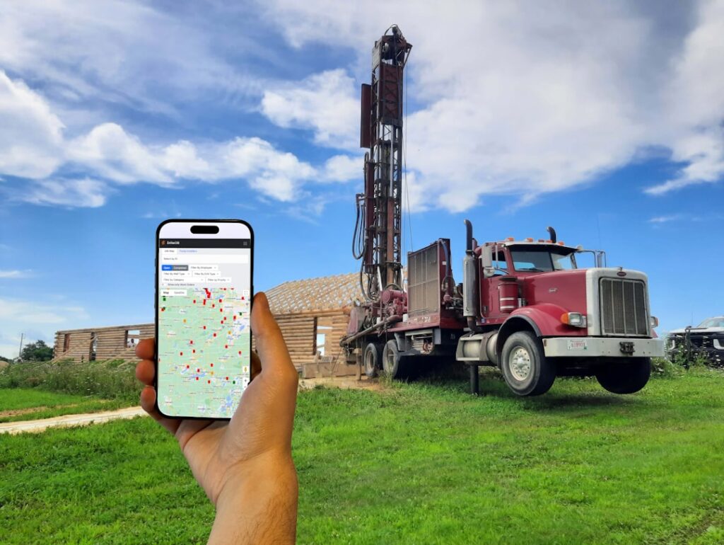 Water Well Drilling Insurance: Expert Guide & Coverage A person holding a cell phone in front of a drilling rig