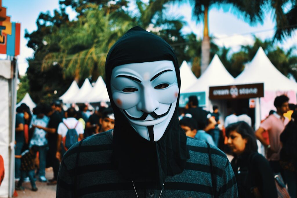 Anonymous Posting Strategy Builds Business Fortune person wearing Guy Fawkes mask near people during day