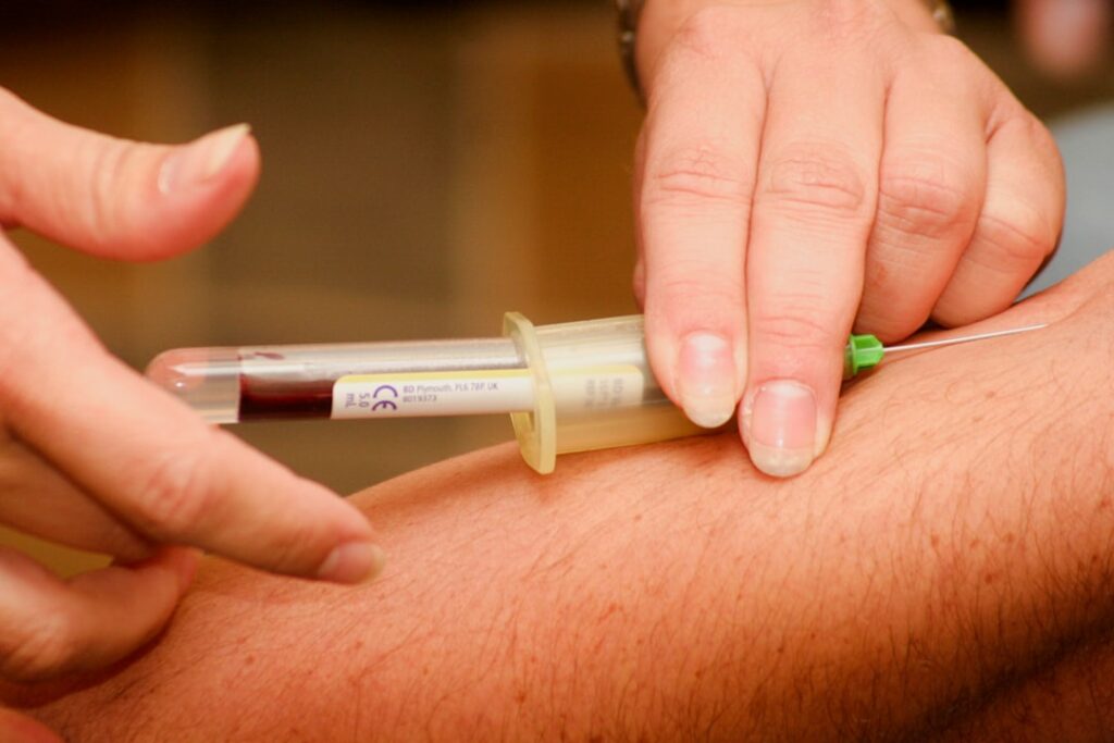 Hormone Testing: When Fatigue Signals Deeper Health Issues person injecting syringe