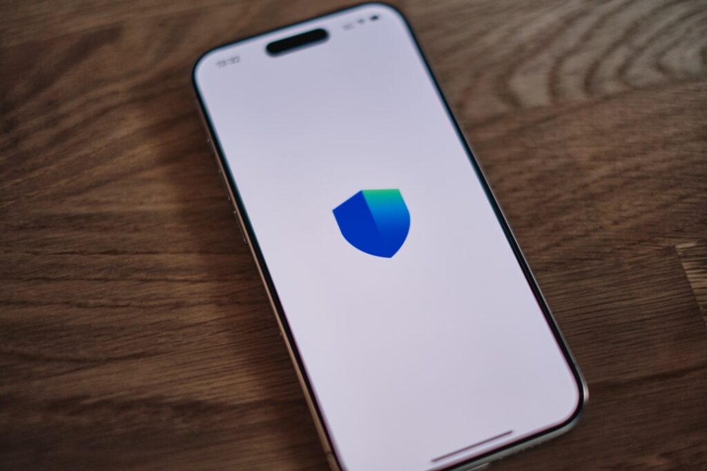 Apple Patches Critical iPhone Bug Exploited by Law Enforcement A cell phone with a shield logo on it