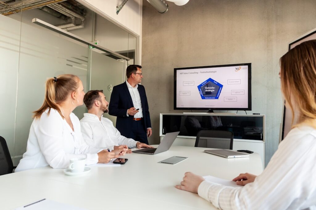 Meta's Employee Tracking Software Ignites Internal Revolt Business meeting with a presenter and colleagues in office.