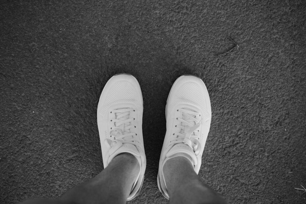 Sole P Shoes: Why Comfort Matters for Your Feet White sneakers standing on textured ground.