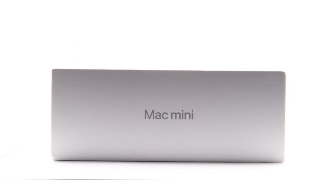 Mac mini Shortage Fuels eBay Price Surge Amid AI Boom a close up of a mac mini on a white surface