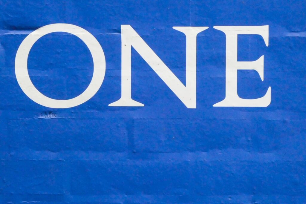 Capital One's $425M Settlement: Your Summer Payout Guide a blue sign that says one on it