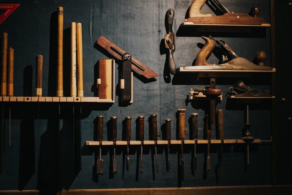 Essential DIY Tools: A Craftsperson's Complete Resource Guide Various woodworking tools neatly arranged on a dark wall.