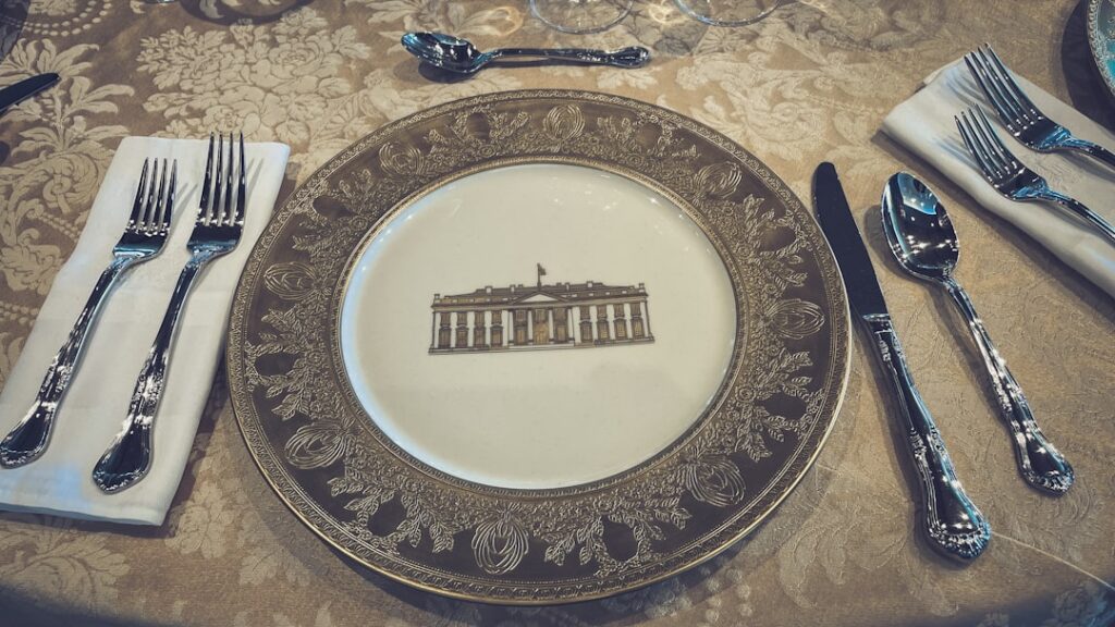Qorvis Hosts Elite WHCD Watch Party at Butterworth's Formal place setting with white house embossed plate.