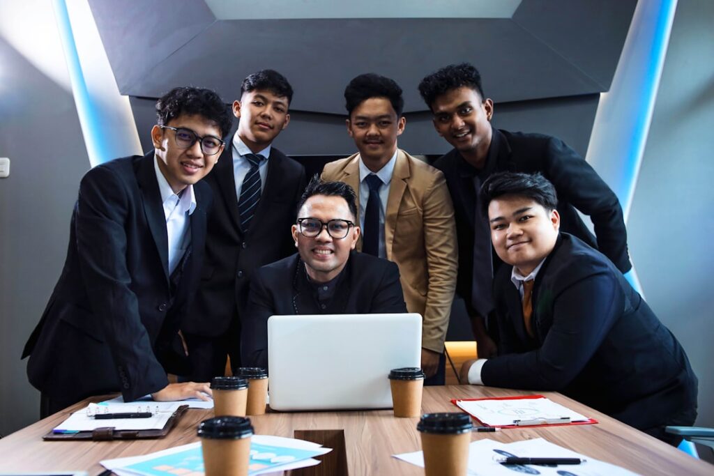 When Leaders Hide: The Cost of Avoidance A team of professionals is gathered around a table.