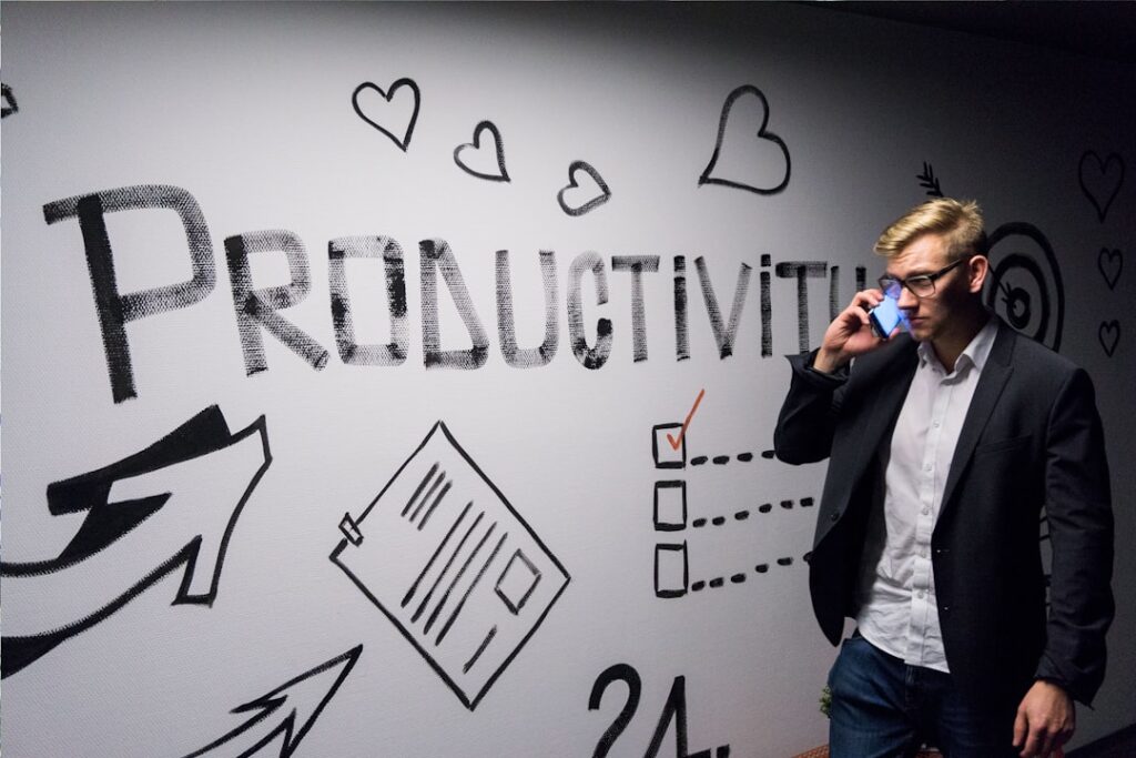 Break Free From Doomscrolling: Apps That Reclaim Your Time man holding smartphone looking at productivity wall decor