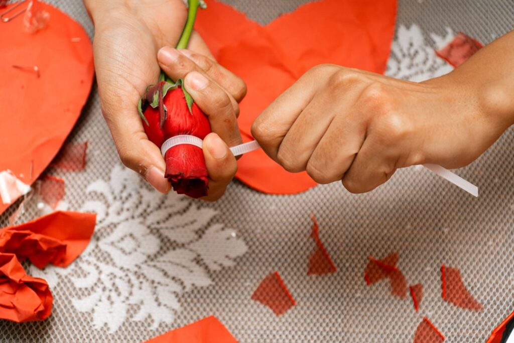 Canton Fair Phase 2: Innovation Reshapes Global Gifts Market Hands crafting red paper hearts with a rose.