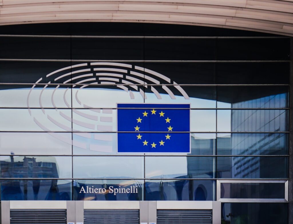 Cohere Acquires Aleph Alpha to Challenge US AI Dominance European union flag on modern building facade