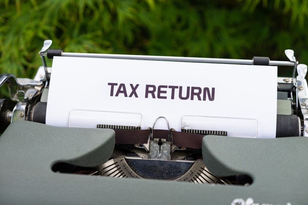 Corporate Income Tax Strategy: Maximize Deductions & Credits a close up of a typewriter with a tax return sign on it