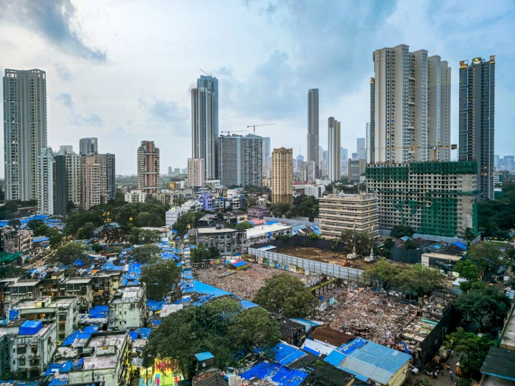 Coventry Dominates Life Settlement Market in 2025 Modern skyscrapers overlook a dense urban slum.