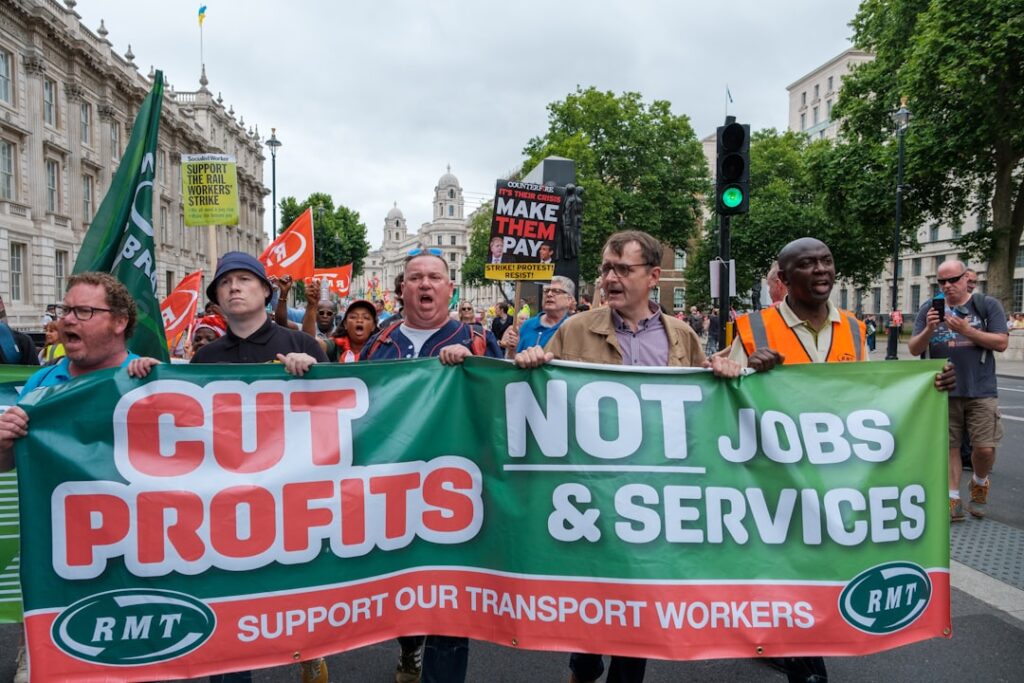 DHL Workers at Jaguar Land Rover Vote for Indefinite Strike a group of people holding a sign