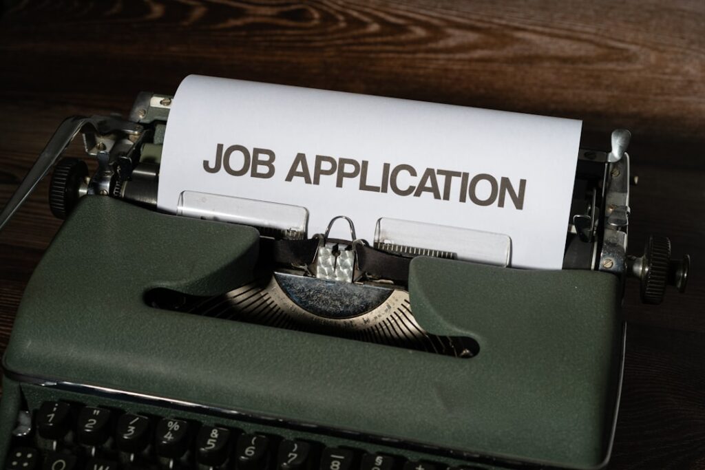 Economic Anxiety in 2028: AI's Impact on Working America a typewriter with a job application printed on it