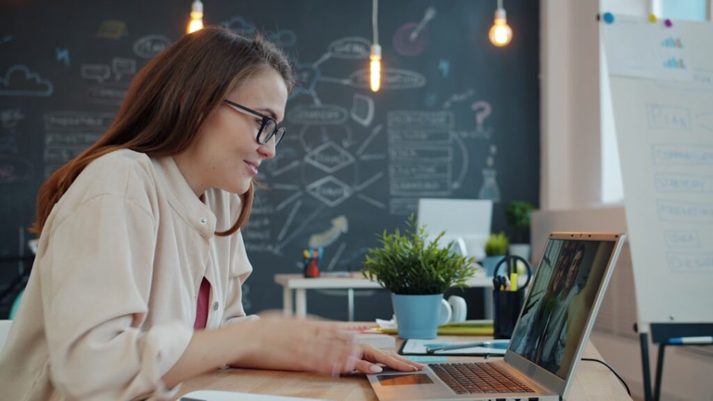 Employee Buy-In: The Real Secret to Digital Transformation Woman working on a laptop in a modern office.