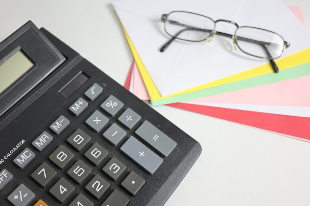 Essential Bookkeeping Guide for Business Financial Success Calculator and glasses on colorful papers