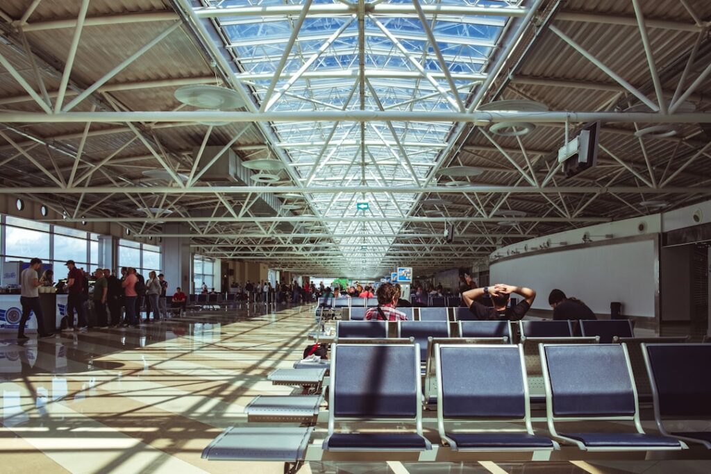 Flight Cancellation & Delay: Know Your Passenger Rights a group of people standing in a waiting area
