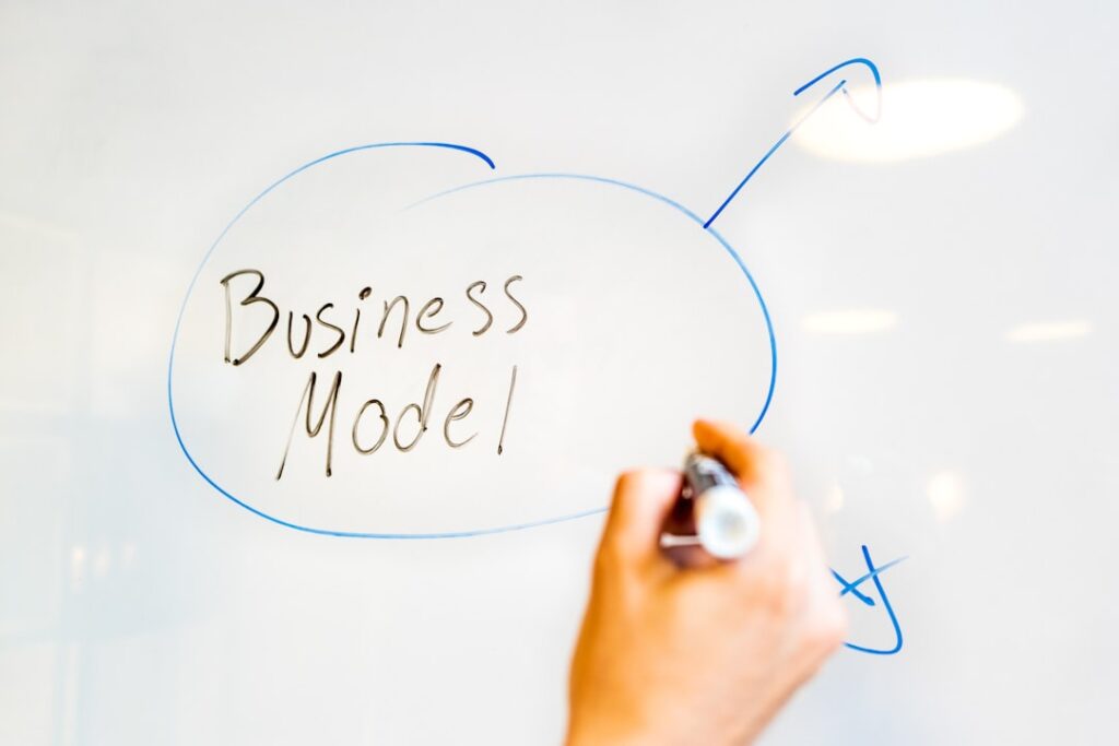 Franchise Economics: The Blueprint for Business Success person writing on white paper
