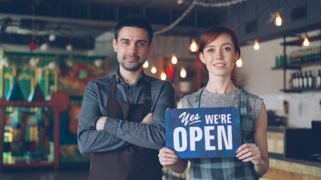 Franchisee Guide: Your Blueprint to Franchise Success A happy couple welcomes customers: we are open.
