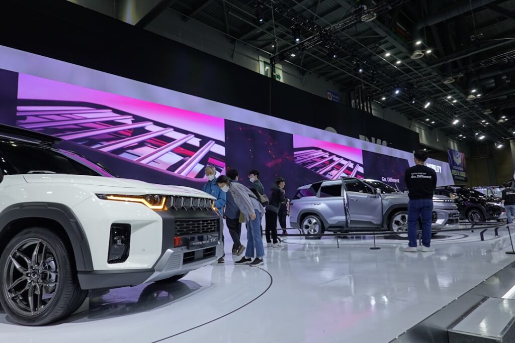 GAC Accelerates Global Expansion at Auto China 2026 a group of people standing around a white suv