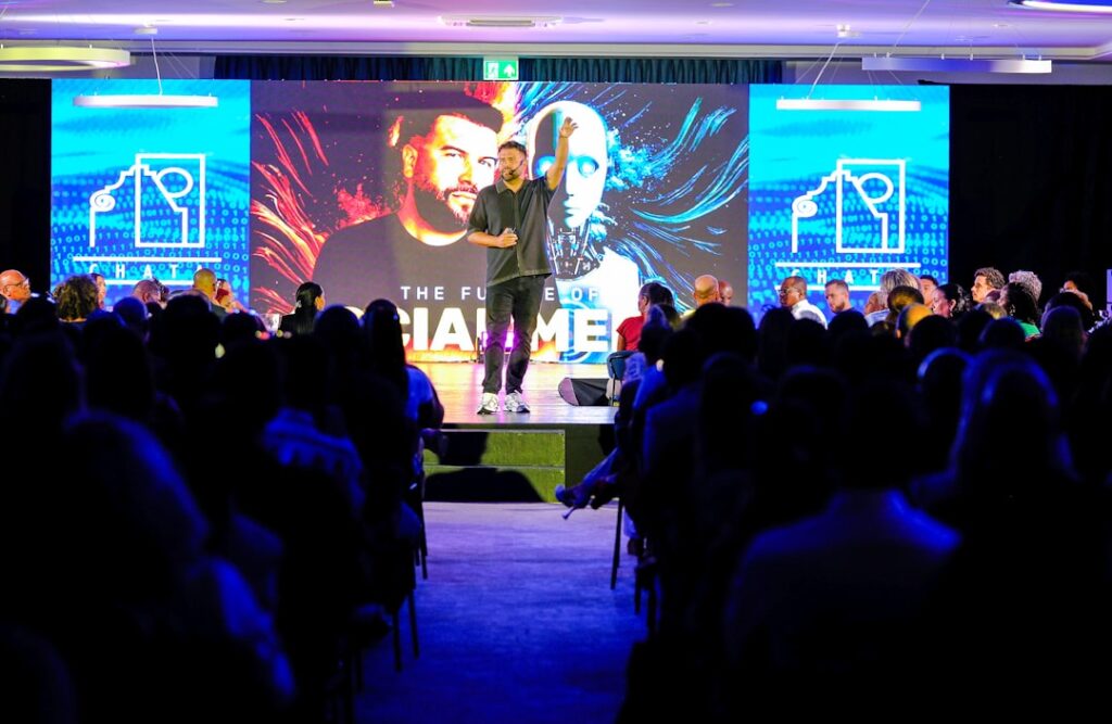 How Solo Entrepreneurs Built $80M Empires With AI Speaker presenting on stage to an audience