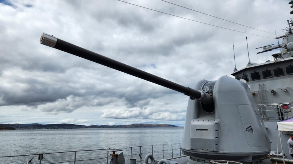 Laser Weapons on Aircraft Carriers: Promise and Peril a cannon on a ship near a body of water