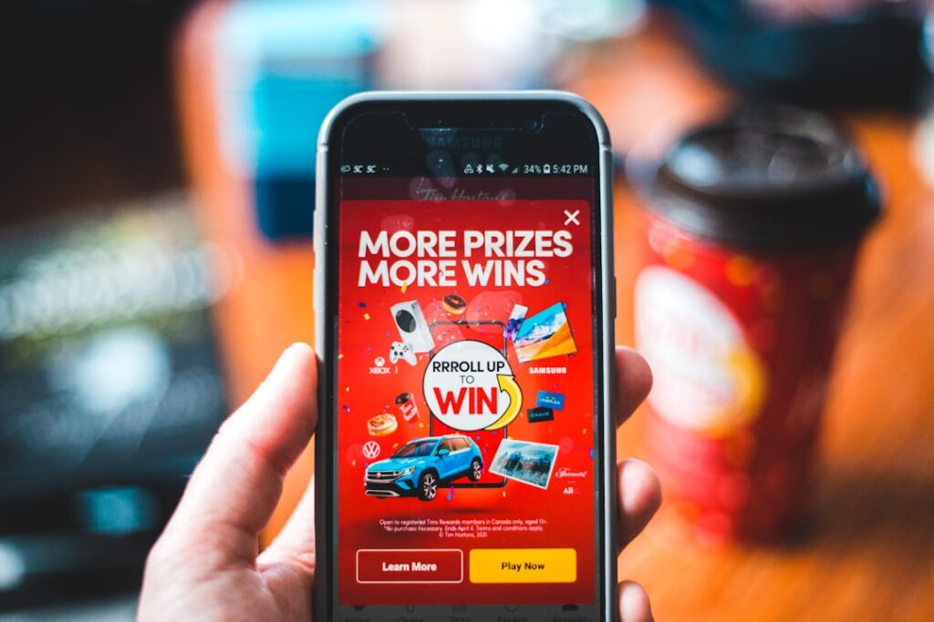 Loyalty Card Platforms: The Complete Business Guide red and black smartphone showing game application