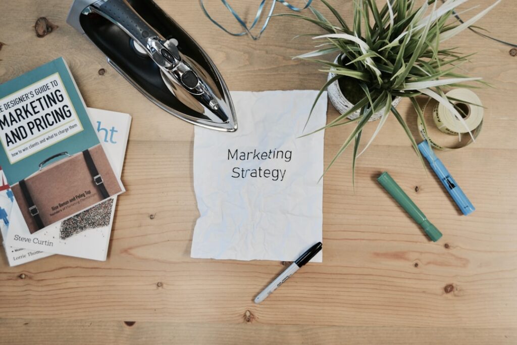 Master Marketing on a Shoestring Budget | Free May 20 Webinar white printing paper with Marketing Strategy text