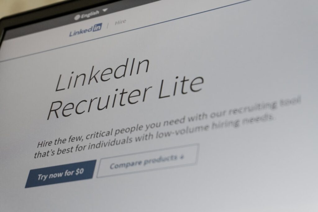 Master the 7-Stage Recruitment Hiring Process Linkedin recruiter lite website on a laptop screen.