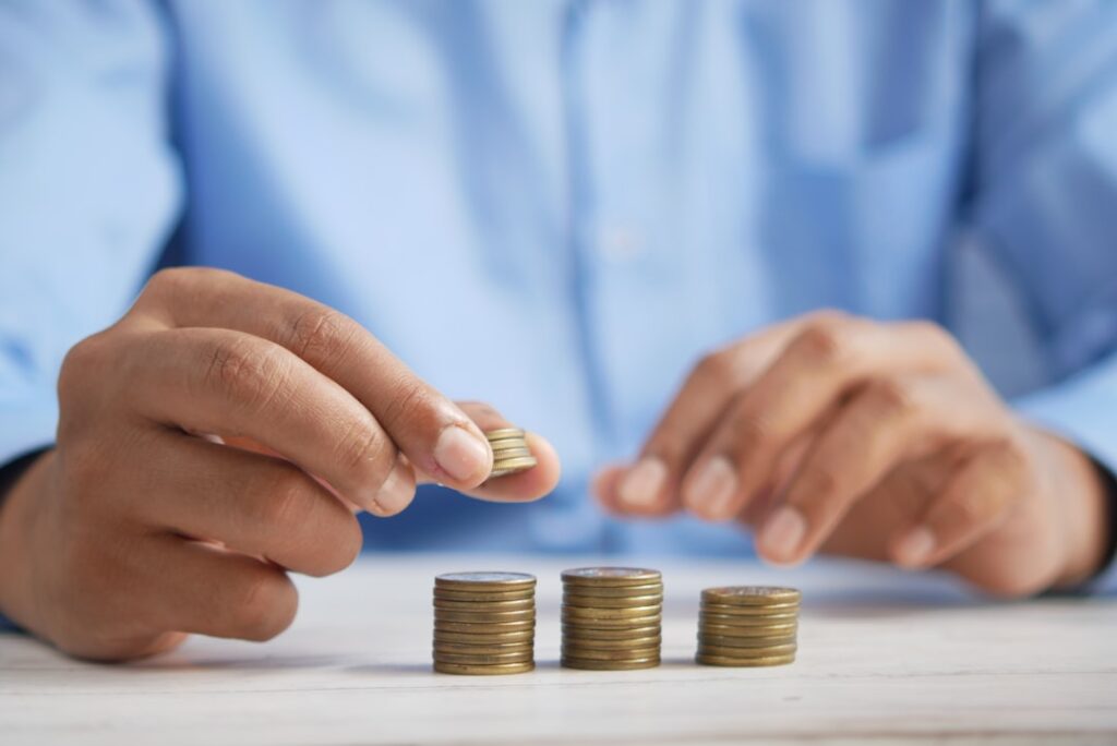 Micro Business Lending: Your Path to Growth a person stacking coins on top of a table