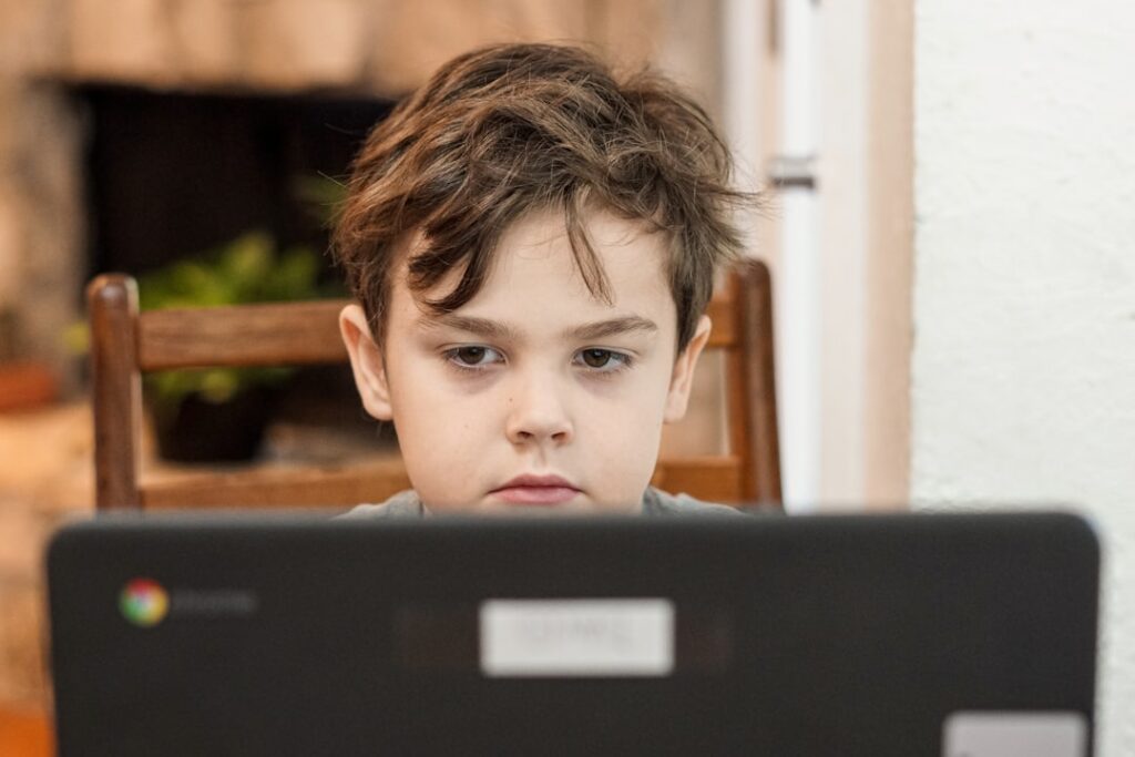 Nations Ban Social Media for Children Amid Safety Concerns boy in black crew neck shirt
