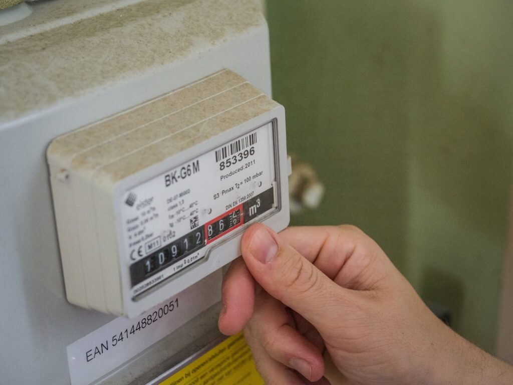 Northern Ireland Energy Crisis May Linger Through Winter a hand holding a white box with a black and red label