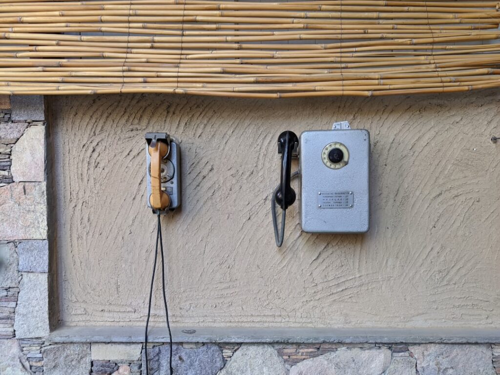 Saramonic WiTalk9 X Wireless Intercom System two old fashioned telephones are attached to a wall