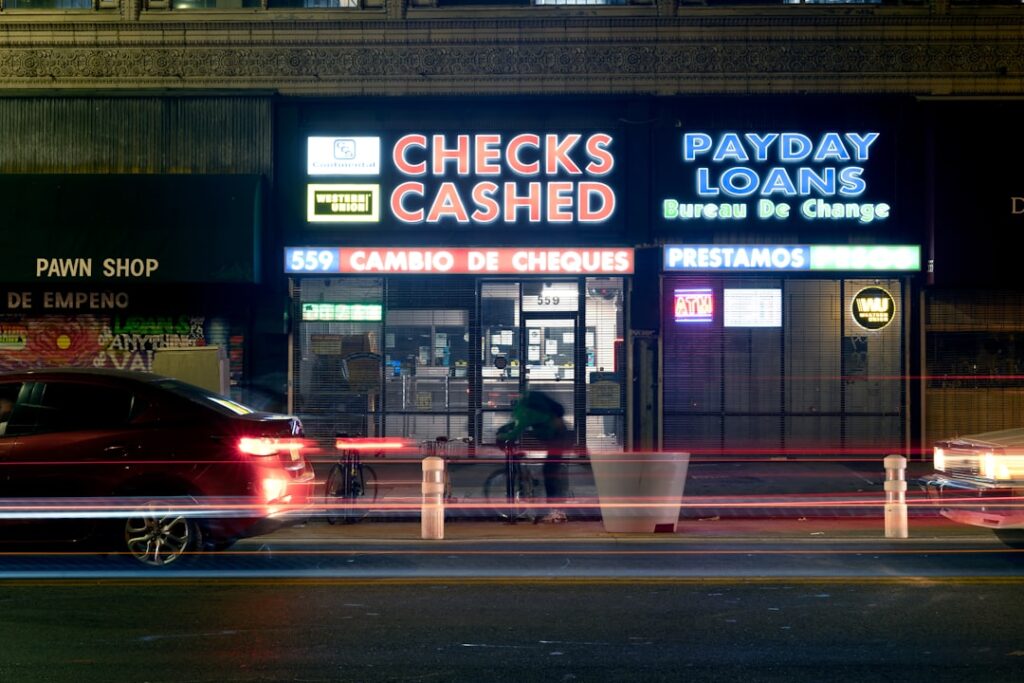 Small Term Loans: Quick Cash With Hidden Costs Neon signs for check cashing and payday loans at night