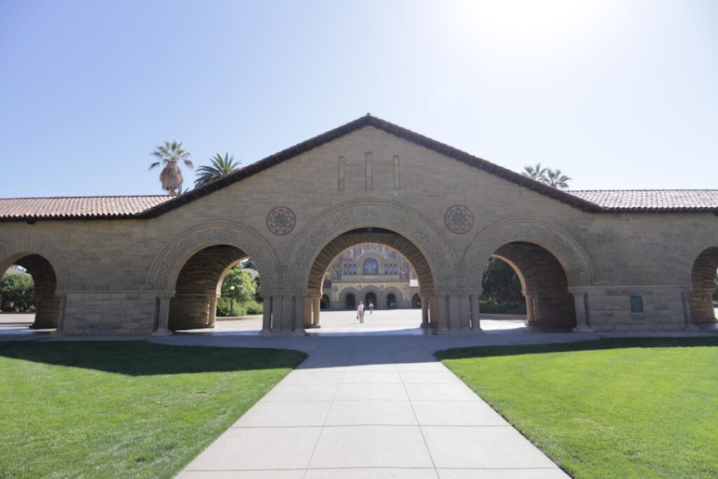 Stanford Students and the Books That Shape Ambition A grand stone archway leads to a building.